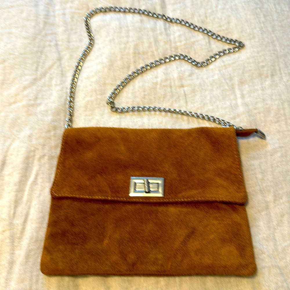 Tan, suede cross body on a silver 40” chain.
